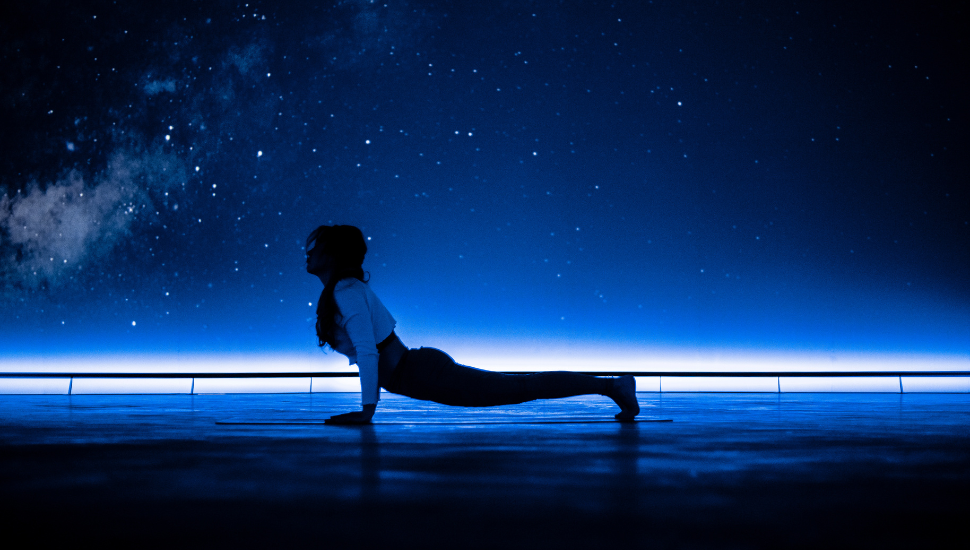 A photograph of someone doing yoga in the immersive dome at The Market Hall.